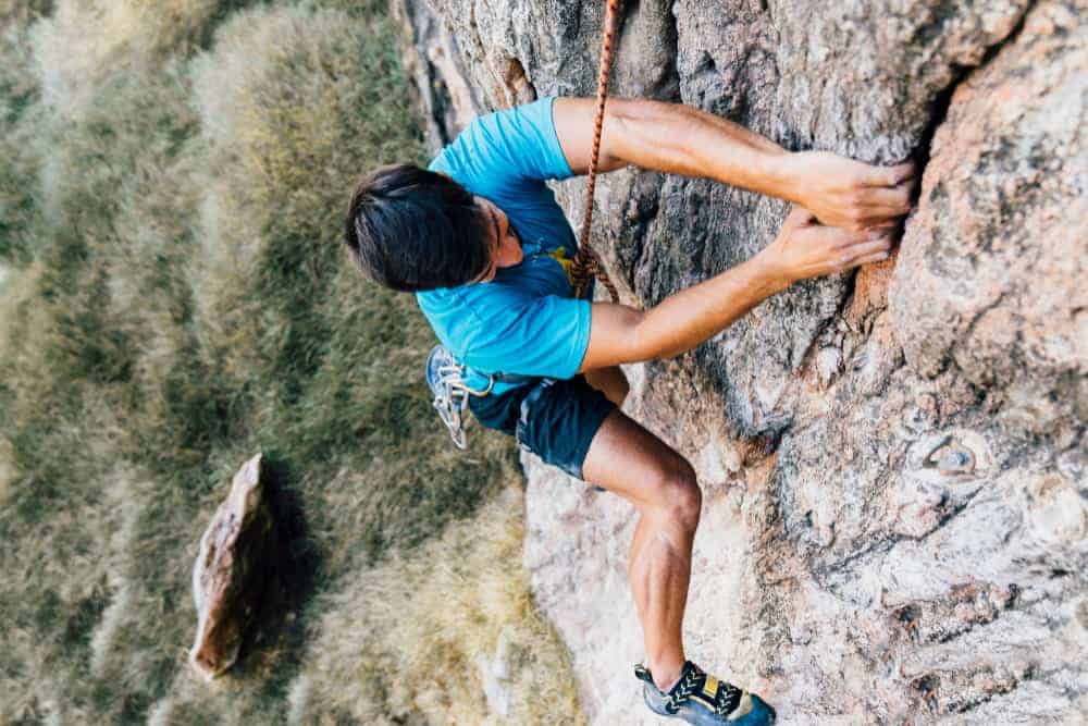 rock-climber-steep-wall-min