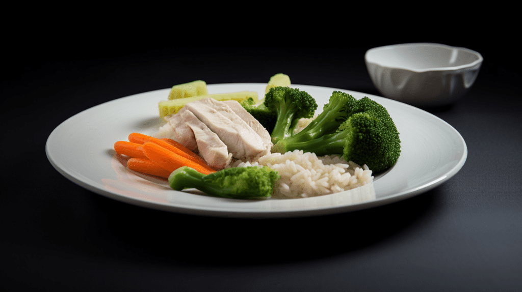 A Bland food diet: A plate of steamed vegetables and boiled chicken breast